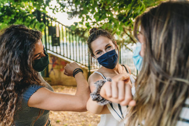 istock Three friends greeting each other with an elbow bump 1254668715