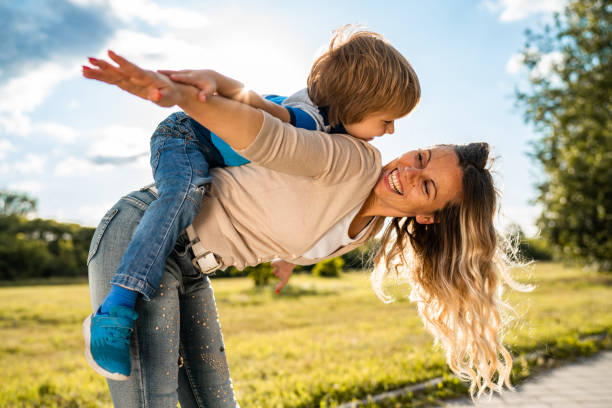 istock Smiling mother is holding her son on back 1254669113
