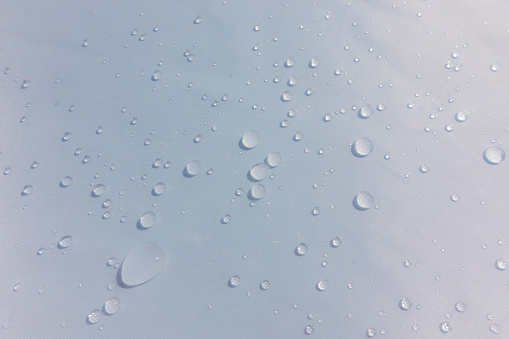Rain drops on waterproof canvas after the storm. Softened photo.