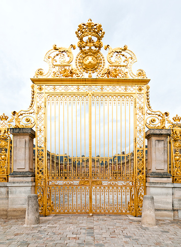 Château de Versailles : the beautiful golden gate, without people, during epidemic Covid 19 virus. It was an official residence of the kings of France and is now a World Heritage Site.  Versailles, near Paris in France. June 27, 2020
