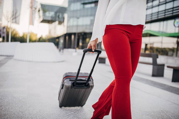 istock Woman pulling her suitcase on the street 1254675621
