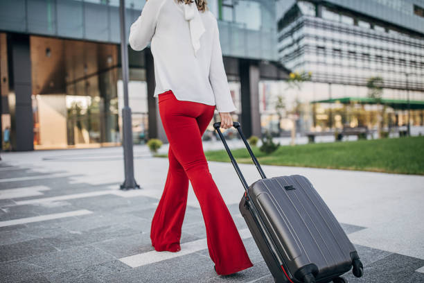 istock Woman pulling her suitcase on the street 1254675635