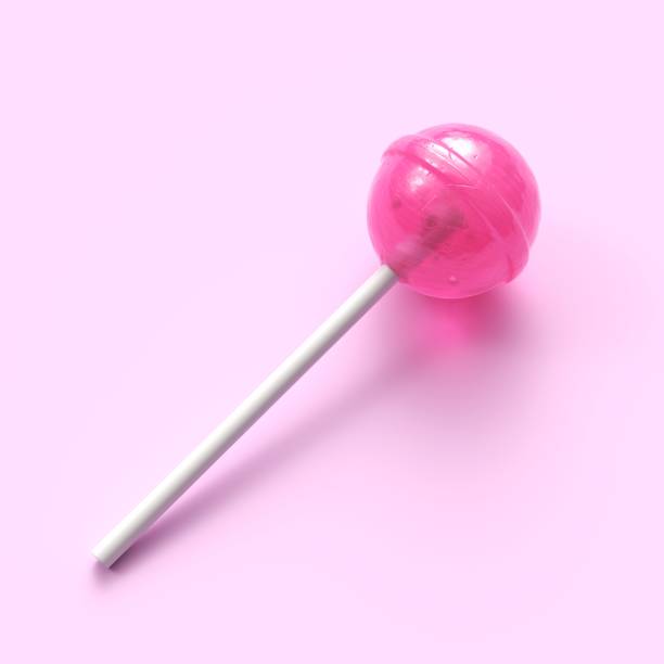 istock Sweet lollipop on stick on pink pastel background 1254675926