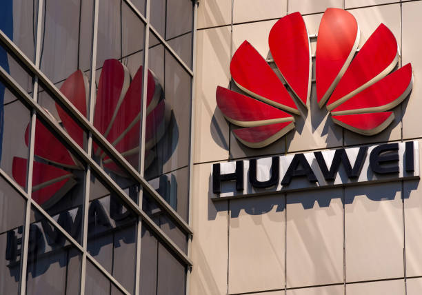 Huawei logo, in Bucharest, Romania. Bucharest, Romania -  June 25, 2020: A logo of Huawei, Chinese telecommunications equipment company, is displayed on the top of a building, in Bucharest, Romania. bucharest photos stock pictures, royalty-free photos & images