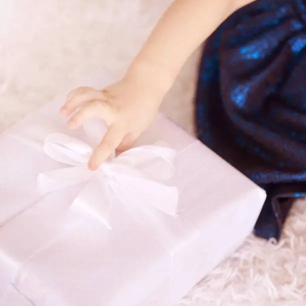 Little girl hold gift box. Cute child hand.