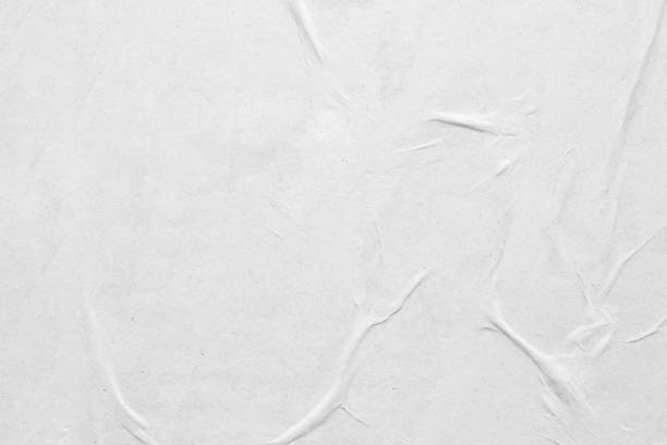 istock Blank white crumpled and creased paper poster texture background 1254683734