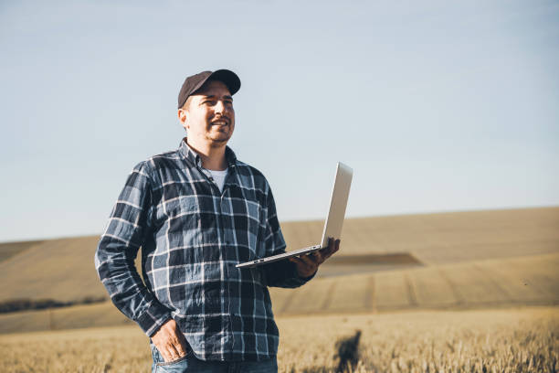 istock Young Modern Farmer Controlled Harvesting On His Agriculture Field 1254683982