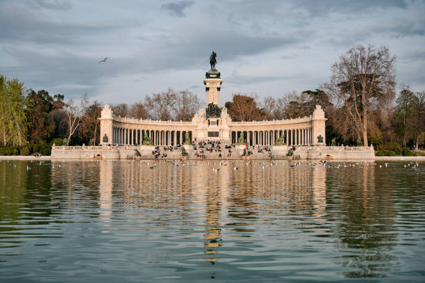 istock Pond and aged monument in park 1254688744