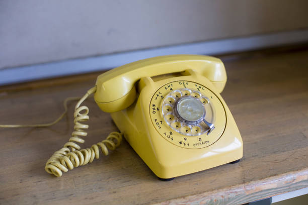 istock Old yellow phone 1254694471