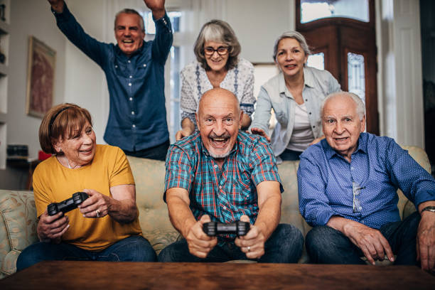 istock Old people playing video games 1254695524