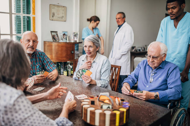 istock Senior people playing cards and having fun in nursing home 1254697142
