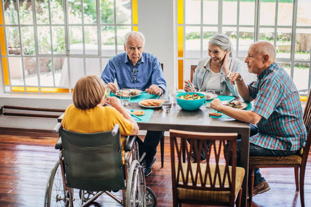 istock Four senior people having dinner together 1254698449