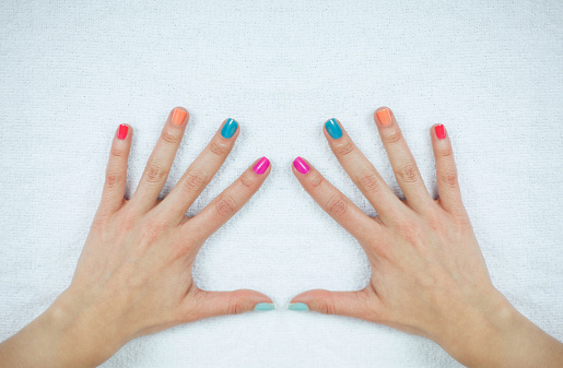 Female hands with a fresh colorful manicure - Lifestyles