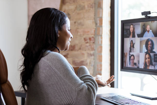 istock Cheerful woman video chats with colleagues 1254704742