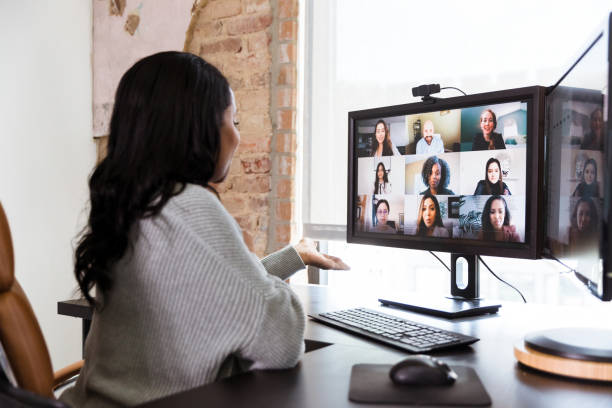 istock Woman gestures while brainstorming with co-workers via video conference 1254705170