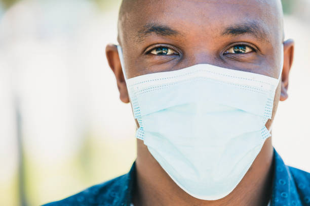 istock Portrait mid adult man wearing protective mask 1254705316