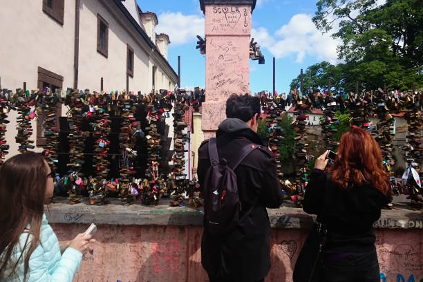 Love locks hang on a bridge in Prague, representing safe friendship and romance in Prague stock photo