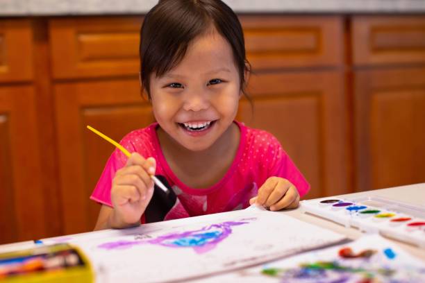 istock Happy preschool kid learning painting at home. 1254707482