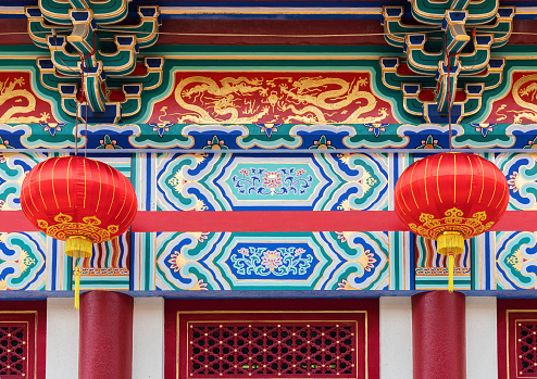 Red Chinese lanterns hanging below pagoda eaves Shanghai