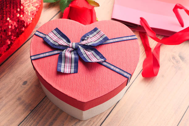 istock Close up of heart shape gift box on table 1254709328