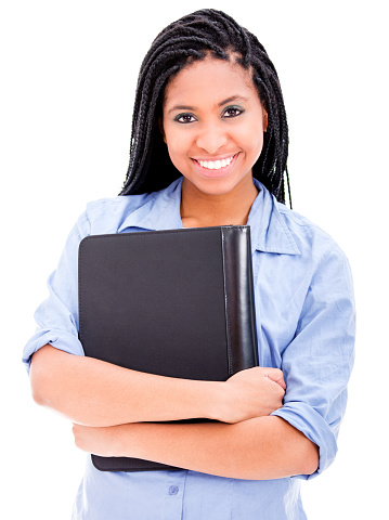 Black young woman holding a binder looking at camera smiling very happy
