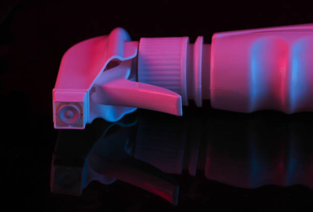 istock Sprayer bottle head in pink-blue neon light on a black background. 1254715764
