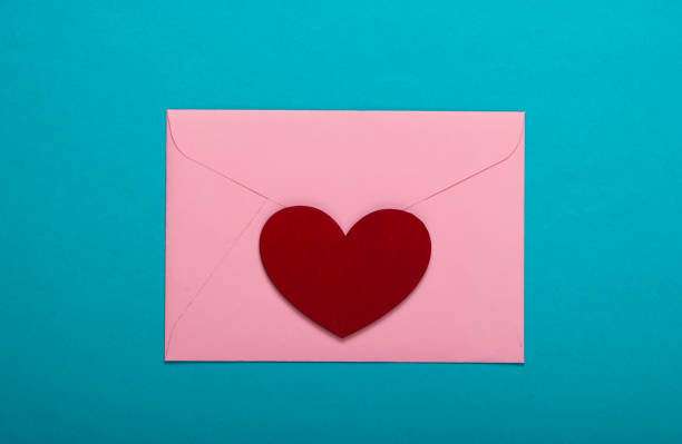 istock Envelope with red heart (valentines) on blue background. Valentine's Day. Top view 1254716757