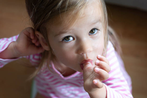 istock Little toddler sucking her thumb. 1254719808
