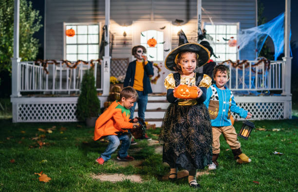 istock Young kids trick or treating at night during Halloween 1254722158