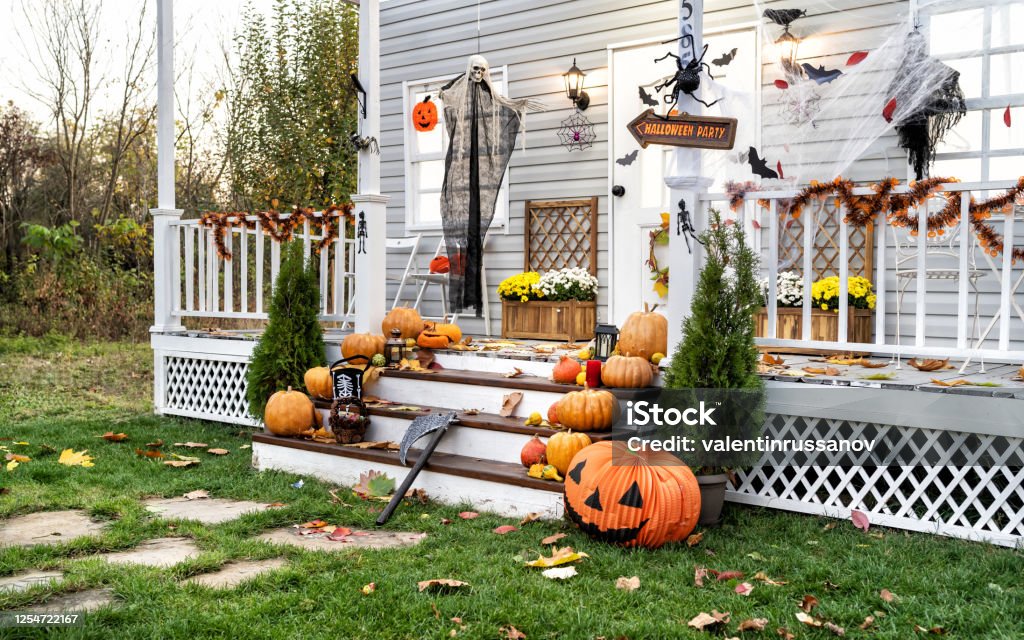 Halloween Jack-o-Lantern Pumpkins on a porch stairs Halloween Stock Photo