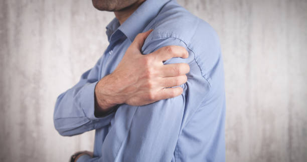 istock Man with a pain in shoulder. 1254722455