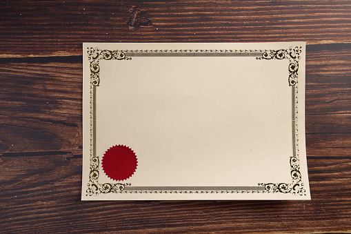 blank certificate on the wood background