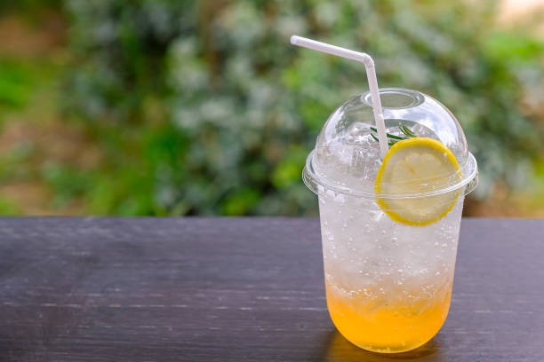 istock Orange Lemon Soda Water on a wooden table 1254723670