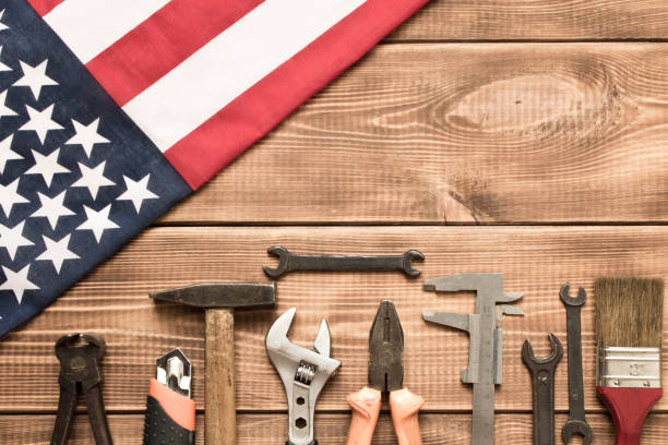 istock Labor day. American flag and various tools on a wooden table. 1254724499
