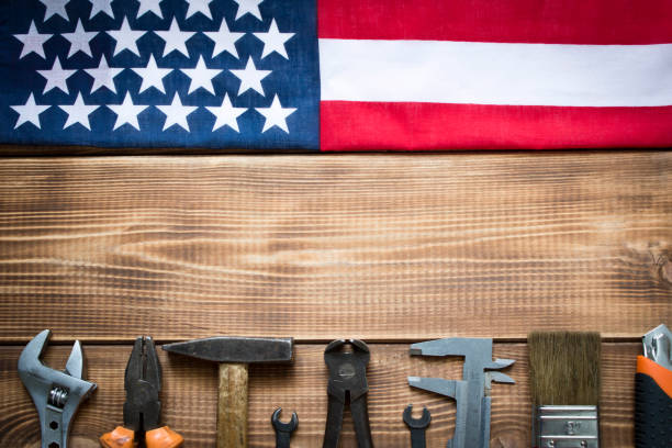 istock Labor day. American flag and various tools on a wooden table. 1254724566