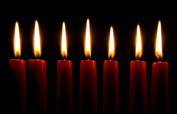 istock Glowing candle lights in the dark 1254724719