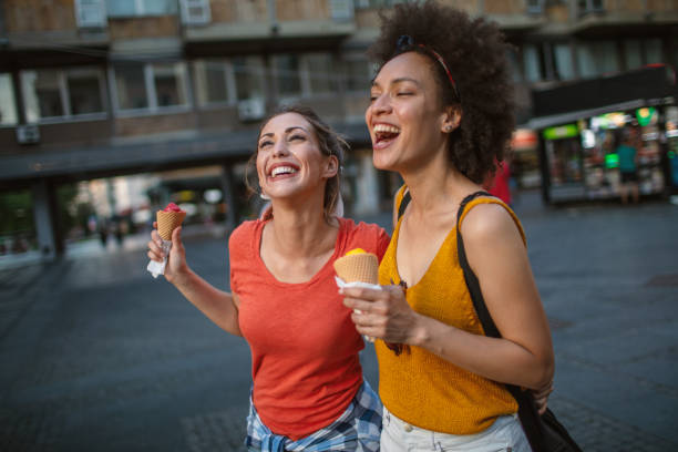 istock Female friends having fun and eating ice cream 1254725352