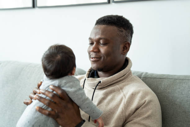 istock Father with newborn son at home 1254725426
