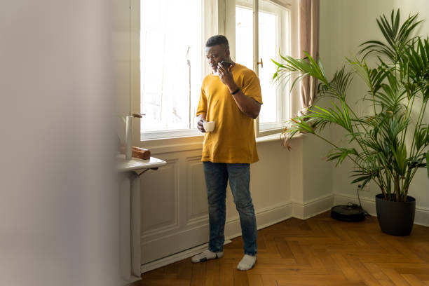 istock Male freelancer talking on smart phone at home 1254727875