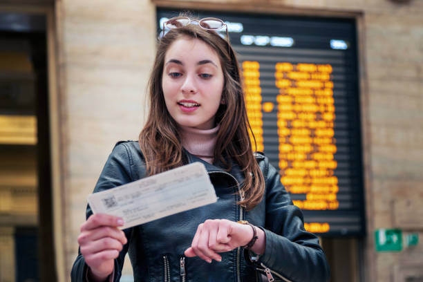 istock Beautiful woman at a train station 1254728093