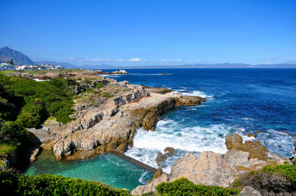 Beautiful seascape in Hermanus Landscape of Atlantic Ocean coastline, waves crashing on the shore on a sunny day in South Africa hermanus stock pictures, royalty-free photos & images