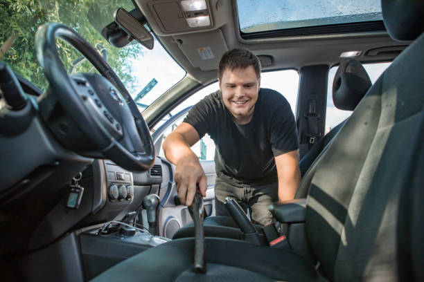 istock man cleaning inside car with vacuum cleaner 1254734171