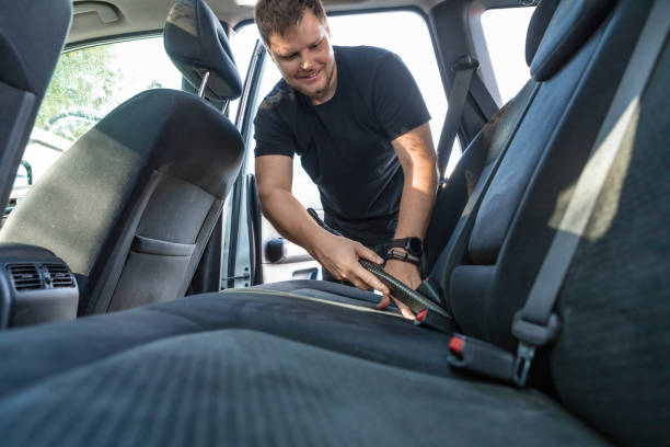 istock man cleaning inside car with vacuum cleaner 1254734608