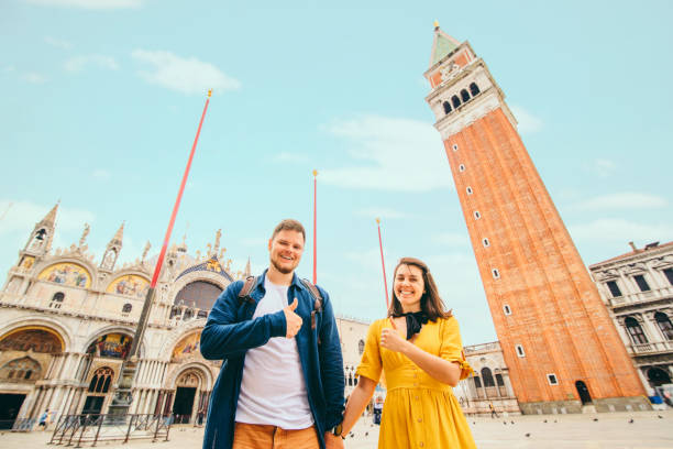 istock couple with thumbs up at saint marks square venice italy 1254735171