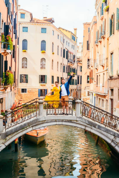 istock couple standing on the bridge crossing venice canals 1254737938