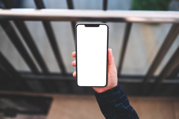 istock a woman holding mobile phone with blank white screen indoors 1254741665