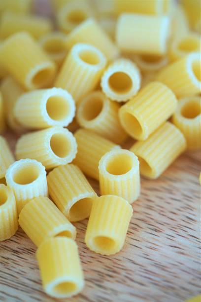 istock Whole wheat Italian pasta macro on wooden surface 1254742938