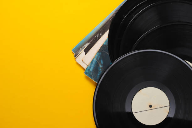 istock Vinyl record albums isolated on yellow background. Copy space. Top view 1254745748