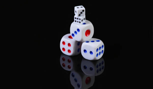 istock Dice on a black background with reflection. Fortune, gaming addiction 1254745912
