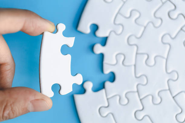 istock Human hands holding white jigsaw  with word problem & solution.  symbol of association and connection. business strategy. 1254746230